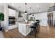 A kitchen with white cabinetry, stainless steel appliances, and a large island with pendant lighting at 3353 N Catawba Way, Aurora, CO 80019