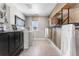 Well-organized laundry room featuring a modern washer and dryer, stylish black cabinets and practical shelving at 3353 N Catawba Way, Aurora, CO 80019