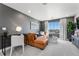 A cozy living room featuring a comfortable sofa, desk, and a large window with a view at 3353 N Catawba Way, Aurora, CO 80019