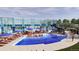 Resort-style pool with lounge chairs, umbrellas, and a waterslide in a modern recreational center at 3353 N Catawba Way, Aurora, CO 80019