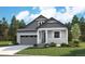 Charming two-story home featuring a well-manicured lawn, gray siding, covered entry and attached garage at 8294 Snake River St, Littleton, CO 80125