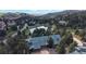 Scenic aerial view of an estate surrounded by lush forest and a private pond at 867 Hill And Dale Rd # B, Golden, CO 80401