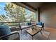 Outdoor balcony with cozy seating and scenic treetop views at 867 Hill And Dale Rd # B, Golden, CO 80401