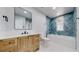Beautiful bathroom featuring new tile, vanity, bathtub, and shower with black fixtures at 867 Hill And Dale Rd # B, Golden, CO 80401