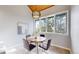 Bright breakfast nook with large windows, a modern table, and views of the lush outdoors at 867 Hill And Dale Rd # B, Golden, CO 80401