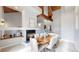 Contemporary dining room featuring a fireplace, wooden beams, and a dining table for six at 867 Hill And Dale Rd # B, Golden, CO 80401