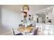 Bright dining area with a round table, modern lighting fixture, and seamless connection to a stylish, remodeled kitchen at 867 Hill And Dale Rd # B, Golden, CO 80401