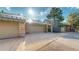 Home exterior featuring attached garages, stone accents, and a paved driveway at 867 Hill And Dale Rd # B, Golden, CO 80401