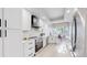 Bright, updated kitchen featuring stainless steel appliances, white cabinets, and stylish fixtures at 867 Hill And Dale Rd # B, Golden, CO 80401