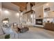 Spacious living room featuring a striking fireplace, wood beam, and an open floor plan at 867 Hill And Dale Rd # B, Golden, CO 80401