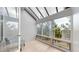 Bright sunroom with large windows offering beautiful views of the surrounding trees and skylights providing ample natural light at 867 Hill And Dale Rd # B, Golden, CO 80401