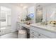 Bathroom with double vanity, natural light, and neutral tones at 1953 Morgan Dr, Erie, CO 80516