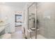 Bathroom featuring a glass shower stall and access to the main bedroom at 1953 Morgan Dr, Erie, CO 80516