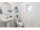 This well-lit half bathroom features a modern sink and tasteful decor at 1953 Morgan Dr, Erie, CO 80516