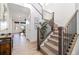 Bright entryway with staircase featuring wood and metal accents, complemented by stylish decor and light wood floors at 1953 Morgan Dr, Erie, CO 80516