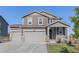 Two-story home showcasing a three-car garage and a welcoming front porch with decorative columns at 1953 Morgan Dr, Erie, CO 80516