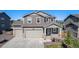 Charming two-story home with a three-car garage, inviting front porch, and neutral-toned exterior at 1953 Morgan Dr, Erie, CO 80516