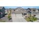 Aerial view of a home with a large driveway and garage, showcasing the landscaped front yard at 1953 Morgan Dr, Erie, CO 80516