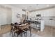 Open-concept kitchen and dining area with island seating, white cabinetry, and modern finishes at 1953 Morgan Dr, Erie, CO 80516