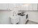 Convenient laundry room with modern washer, dryer, and utility sink at 1953 Morgan Dr, Erie, CO 80516