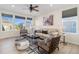 Inviting living room with large windows, comfortable seating, ceiling fan, and decorative rug at 1953 Morgan Dr, Erie, CO 80516