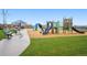 A colorful playground with multiple slides, climbing structures, and benches for parents at 1953 Morgan Dr, Erie, CO 80516