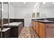 Bathroom with double vanity, soaking tub, and pebble tile floor at 250 Laramie Blvd, Boulder, CO 80304