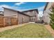 Large backyard featuring a green lawn, gravel area, and a hot tub perfect for outdoor activities and relaxing at 6619 Mariposa Ct, Denver, CO 80221