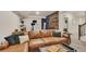 Finished basement with brown leather sofa, wood paneling, desk, and modern decor create a stylish and inviting space at 6619 Mariposa Ct, Denver, CO 80221