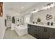 Bright bathroom featuring a soaking tub, walk-in shower, double vanity with modern fixtures and neutral tones at 6619 Mariposa Ct, Denver, CO 80221