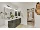 Bathroom vanity featuring double sinks, modern fixtures, and contemporary design; view into bedroom at 6619 Mariposa Ct, Denver, CO 80221