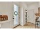 Bright entryway featuring a frosted glass door, decorative wreath, and stylish mail organizer at 6619 Mariposa Ct, Denver, CO 80221