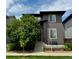 Charming two-story home with a landscaped yard, a small porch, and modern architectural details at 6619 Mariposa Ct, Denver, CO 80221