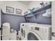 Well-organized laundry room with modern appliances, custom shelving, and charming decor at 6619 Mariposa Ct, Denver, CO 80221