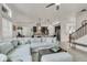 Spacious living room with modern sectional sofa, open to kitchen, and ample natural light at 6619 Mariposa Ct, Denver, CO 80221