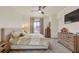 Comfortable main bedroom featuring a ceiling fan, natural light, and neutral tones at 6619 Mariposa Ct, Denver, CO 80221