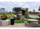 Outdoor seating area with tables and chairs under a canopy, surrounded by landscaping at 6619 Mariposa Ct, Denver, CO 80221