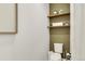 Cozy powder room with floating shelves, fresh plants, and updated fixtures at 6619 Mariposa Ct, Denver, CO 80221