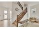 Inviting staircase with wooden handrail, carpeted treads, and stylish landing decor at 6619 Mariposa Ct, Denver, CO 80221