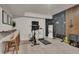 Bright workout room featuring modern exercise equipment, a stylish accent wall, and bar seating at 6619 Mariposa Ct, Denver, CO 80221
