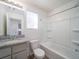 Bathroom with granite vanity, a window, and a shower-tub combo at 46549 Avery Ln, Bennett, CO 80102