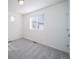Comfortable bedroom with neutral carpet, window, and fresh white walls at 46549 Avery Ln, Bennett, CO 80102