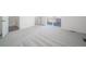 Spacious bedroom featuring neutral-toned carpet, recessed lighting, and bright natural light at 46549 Avery Ln, Bennett, CO 80102