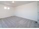 Spacious bedroom featuring neutral-toned carpet, recessed lighting, and bright natural light at 46549 Avery Ln, Bennett, CO 80102