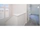 Bright hallway with plush gray carpeting, a window letting in natural light, and access to other rooms at 46549 Avery Ln, Bennett, CO 80102