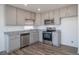 Charming kitchen with stainless steel appliances and granite countertops at 46549 Avery Ln, Bennett, CO 80102
