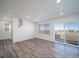 Open-concept living room with sleek gray floors and large sliding glass doors at 46549 Avery Ln, Bennett, CO 80102