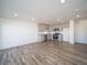 Open living space with kitchen featuring stainless steel appliances and gray cabinets at 46549 Avery Ln, Bennett, CO 80102