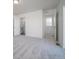Bright main bedroom boasts neutral-toned carpet with an ensuite bath and walk in closet at 46549 Avery Ln, Bennett, CO 80102
