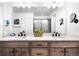 Modern bathroom featuring a double vanity, a large mirror, and contemporary black fixtures at 4739 Gray Wolf Ln, Castle Rock, CO 80104